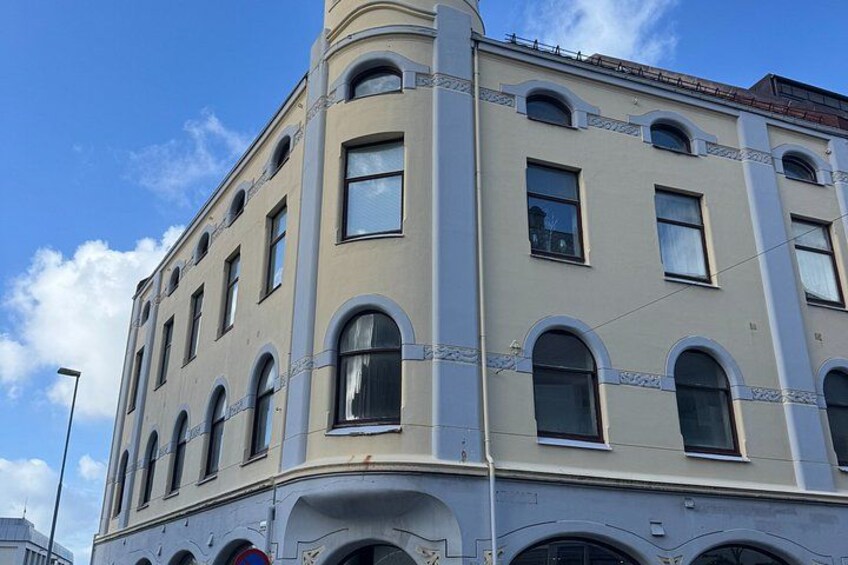 A corner building with arched windows and a curved facade. 4