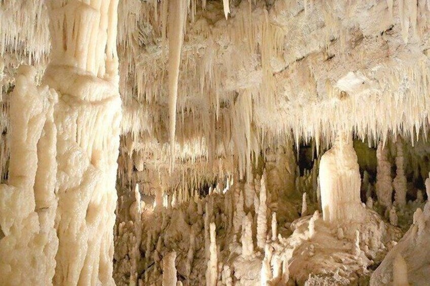 A cave with stalactites hanging from the ceiling. 1