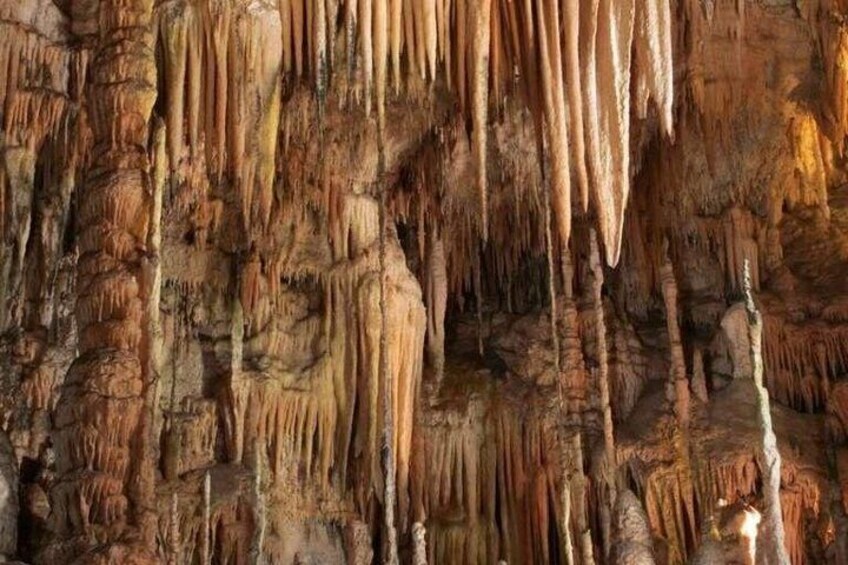A cave with stalactites hanging from the ceiling. 4