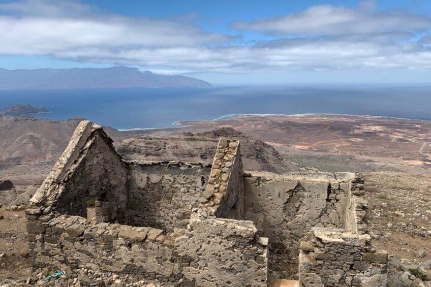 Ancient ruins with a coastal landscape in the background. 4