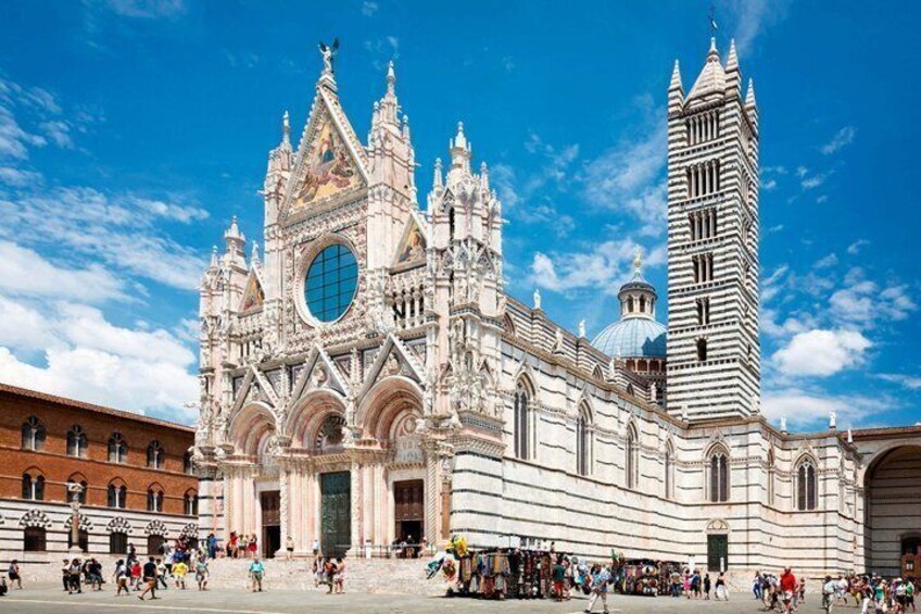 A grand cathedral with intricate architecture, a prominent tower, and a bustling square. 3