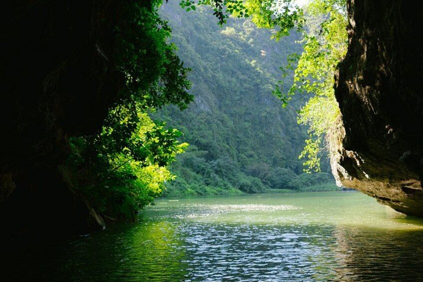 A river flowing through a forested gorge with rocky cliffs on either side. 3