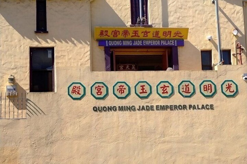A building facade with signage in both Chinese and English, reading 'QUONG MING JADE EMPEROR PALACE.' 4