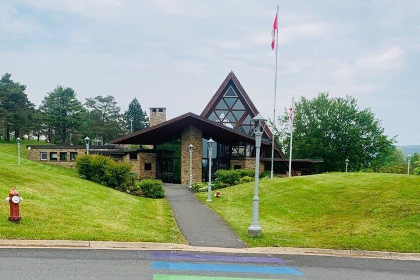 A building with a triangular roof, a flagpole, and a fire hydrant. 5
