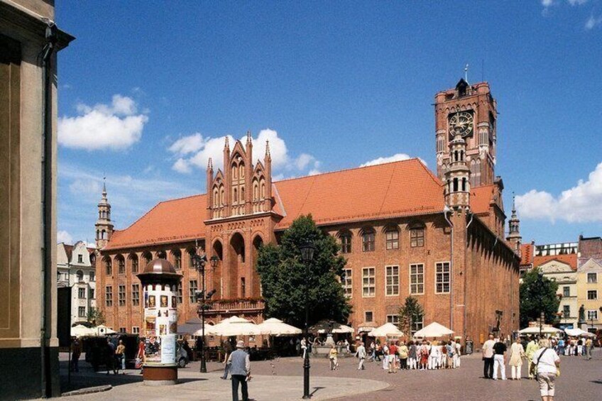 A historic building with a clock tower and arched windows. 5