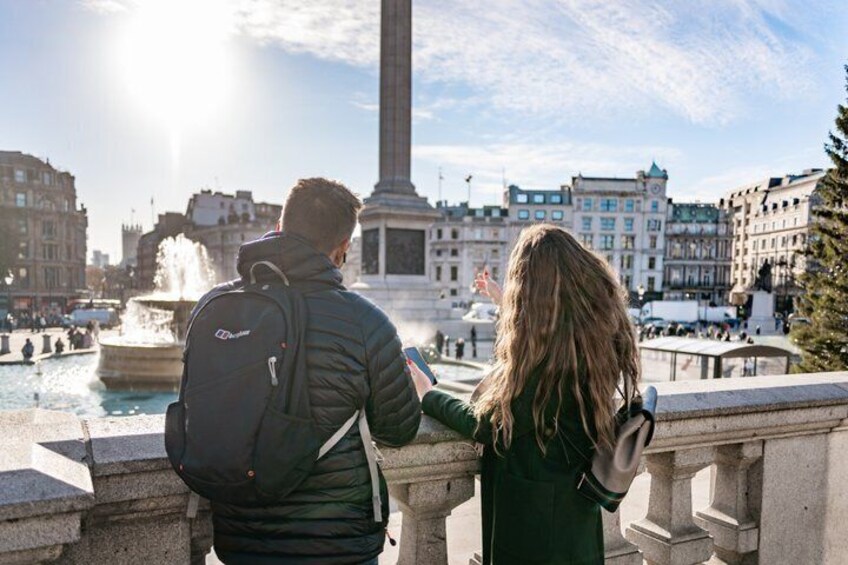 A couple standing by a fountain with a monument in the background. 5