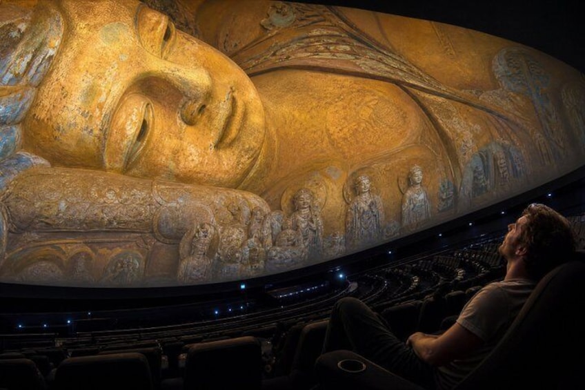 A large golden Buddha statue in a theater. 4