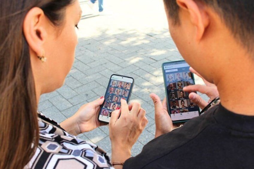 Two people using smartphones, one with a patterned shirt and the other in a dark shirt, holding their devices. 5