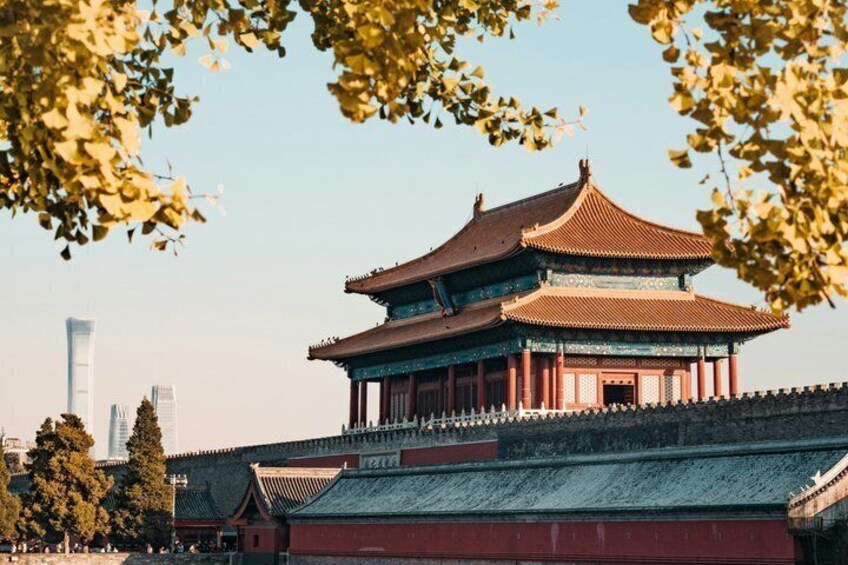 A traditional Chinese building with a multi-tiered roof, surrounded by a low wall and trees. 4