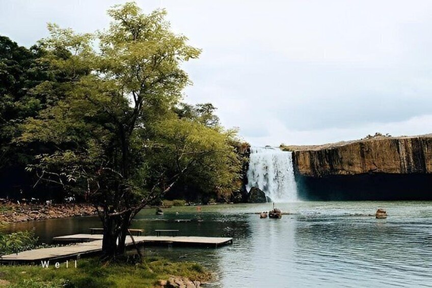 A waterfall, a tree, and a dock. 1