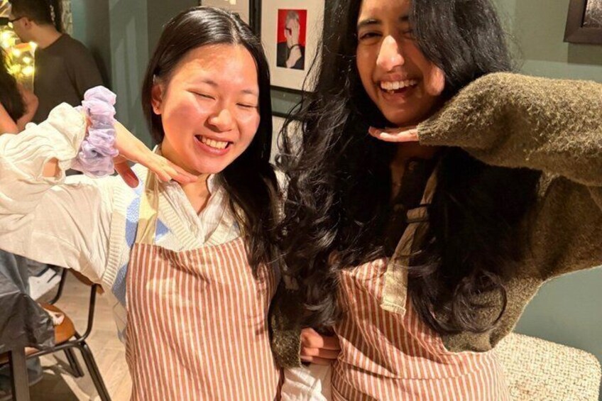 Two people in a salon, one holding a purple object. 1