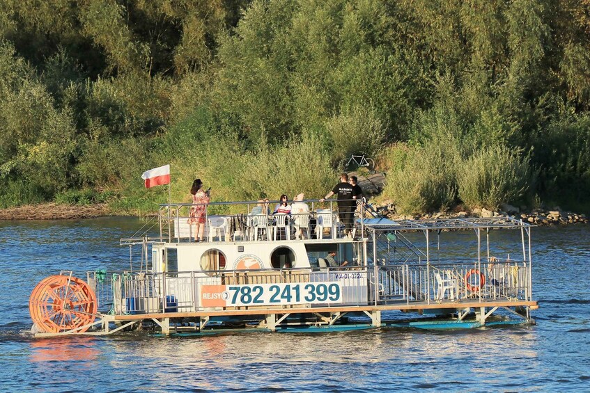 A riverboat with people on board, a flag, and a phone number. 5