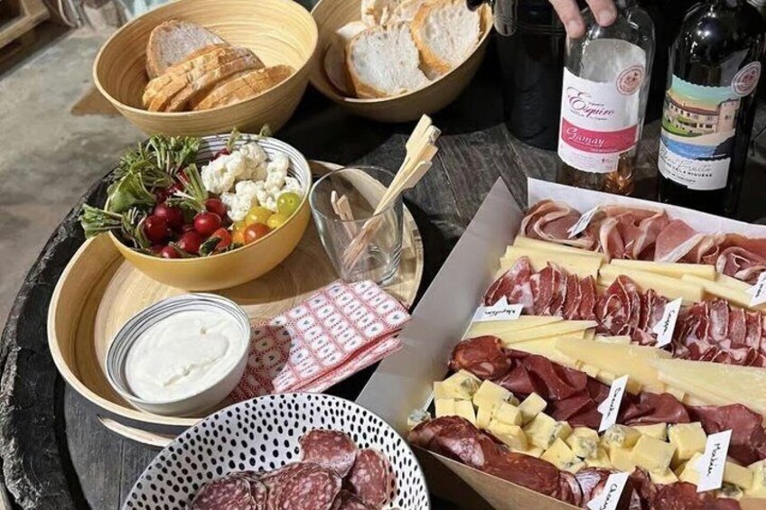 A charcuterie board with various meats, cheeses, and bread. 1