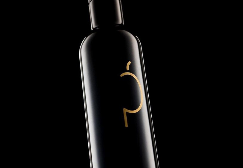 A black bottle with a gold logo. 1