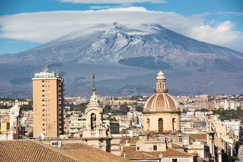 A cityscape with a prominent mountain in the background, a tall building, and a dome structure. 5
