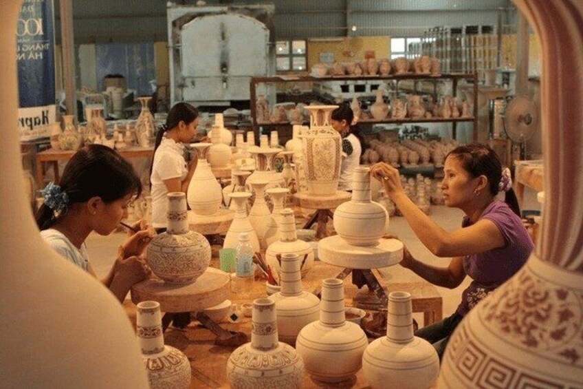 A pottery workshop with artisans shaping clay pots. 2