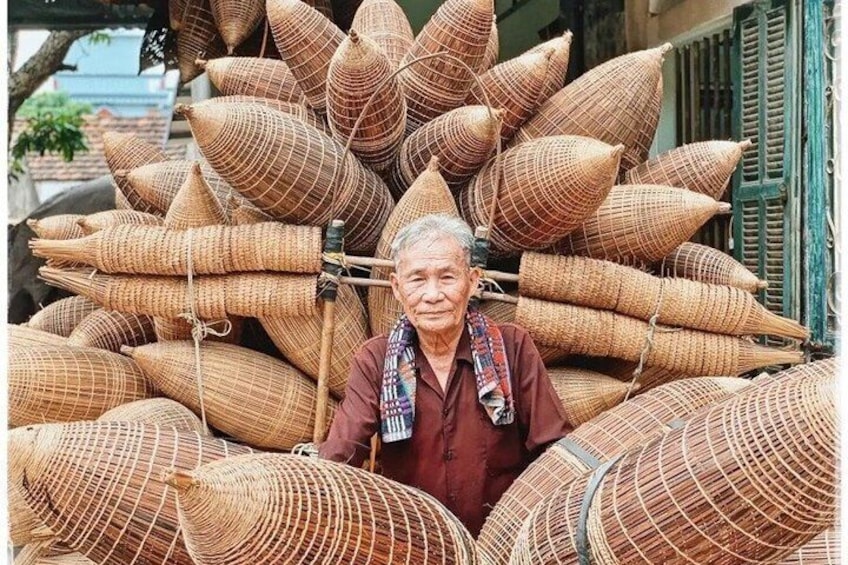 A person surrounded by large woven baskets. 1