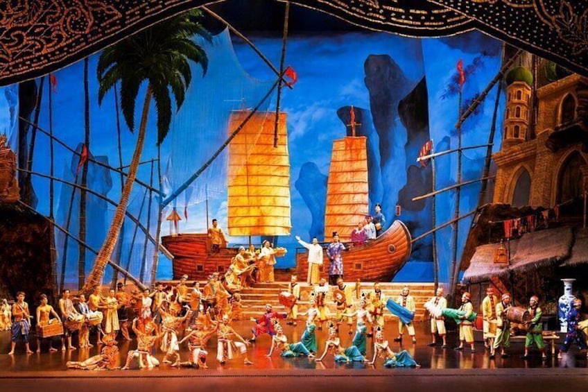 A stage with a large ship, palm trees, and a tropical backdrop. 5