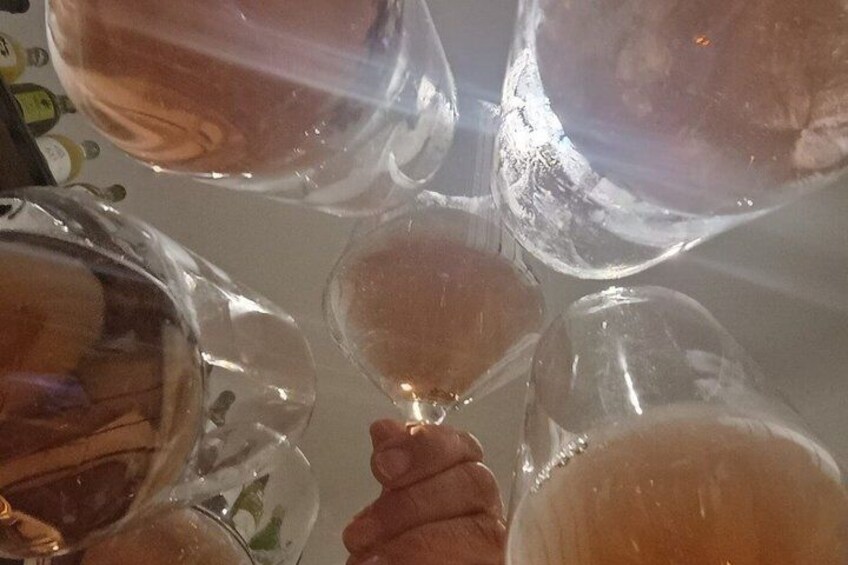 A person holding a clear plastic cup with a beverage. 5