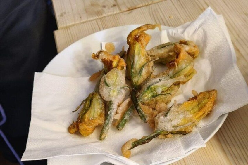 A plate of fried okra with a white paper liner. 3