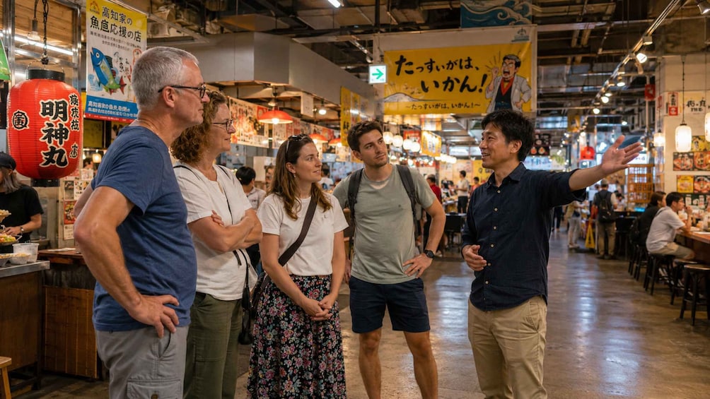A bustling indoor market with people shopping and interacting. 3
