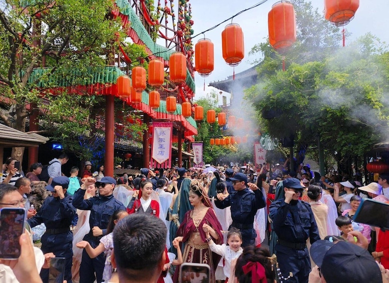 A crowded street with traditional architecture, red lanterns, and people in traditional attire. 5