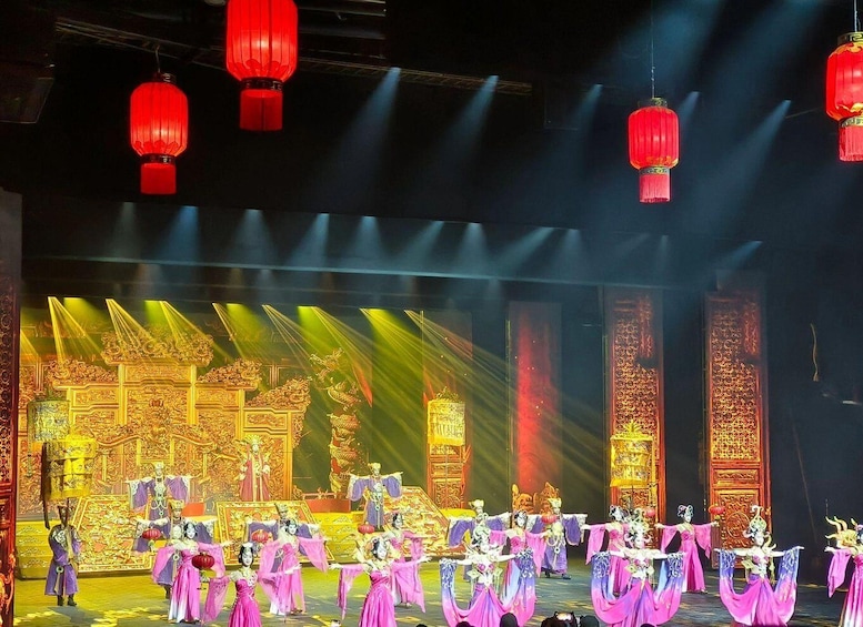 A stage with performers in traditional costumes, red lanterns, and ornate golden backdrops. 4