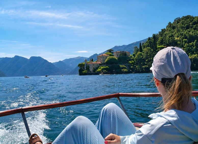 A woman on a boat with a mountainous landscape in the background. 3