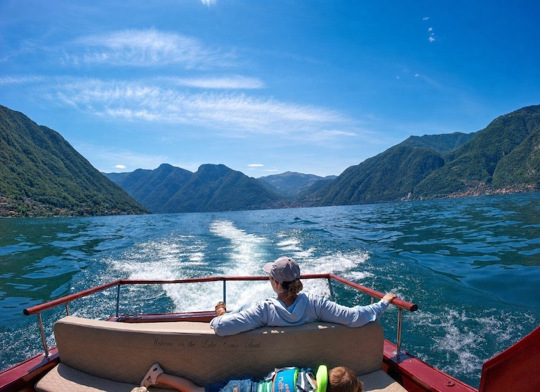 A boat on a lake with mountains in the background. 4