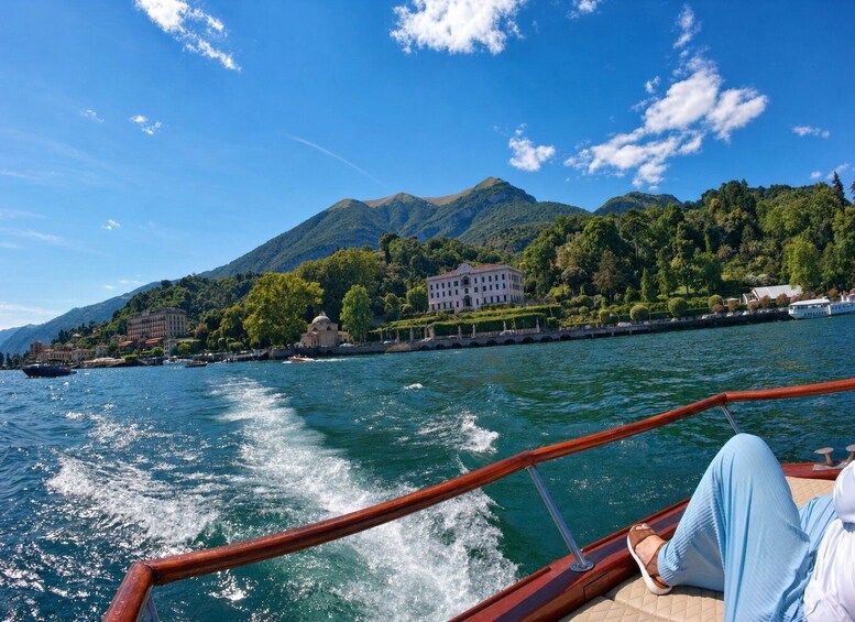 A boat on a lake with mountains in the background. 5