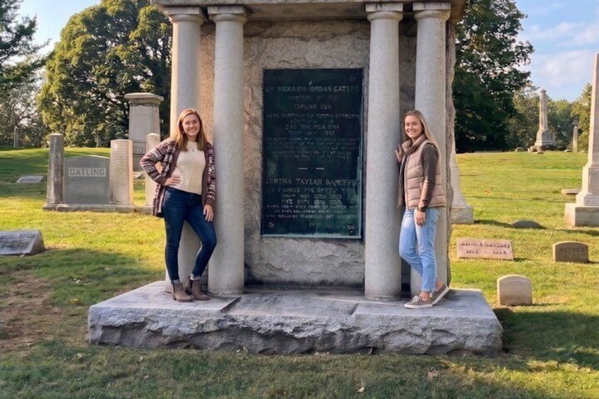 A memorial monument with inscriptions, surrounded by a cemetery with gravestones. 4