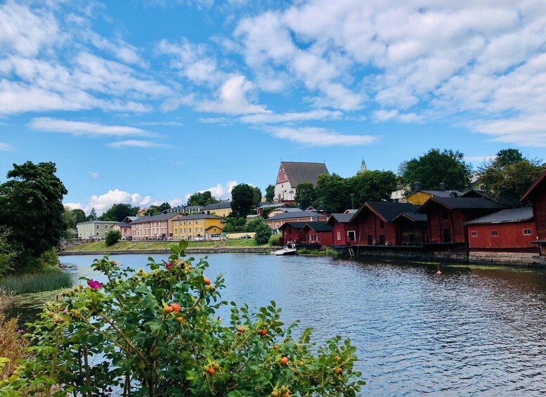 A river with buildings on the banks, a church, and a clear sky. 4