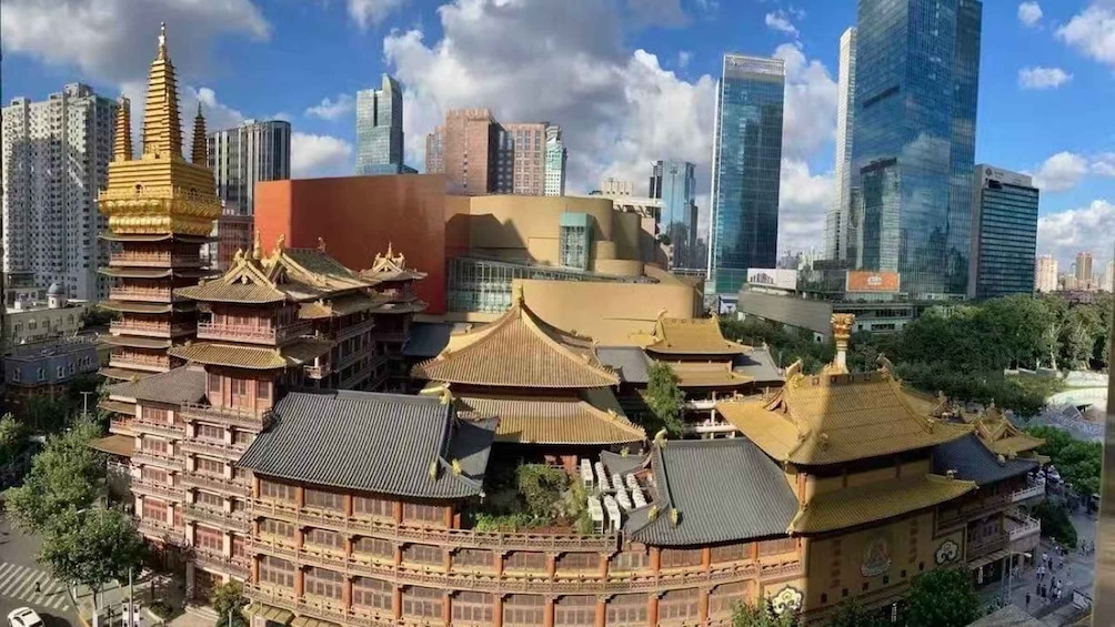 A traditional Chinese temple complex surrounded by modern skyscrapers. 4
