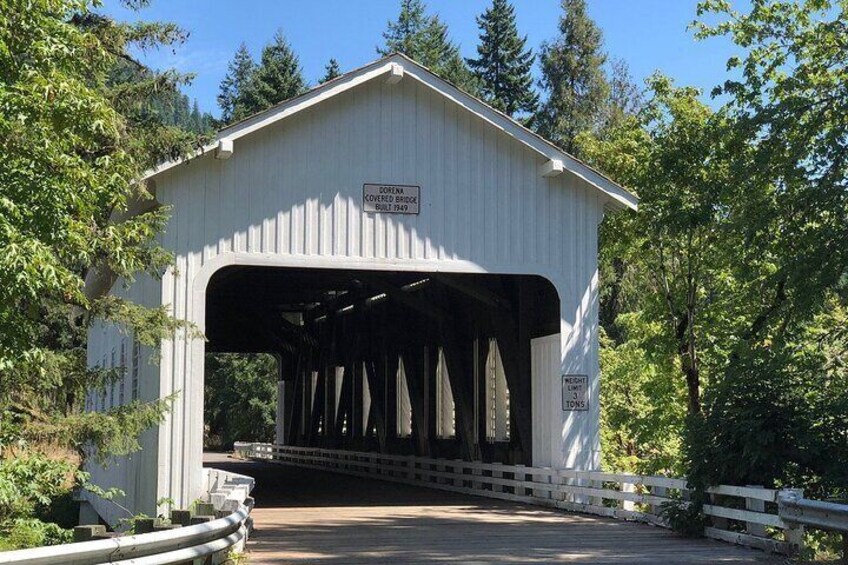 A covered bridge with a sign indicating it was built in 1849. 1