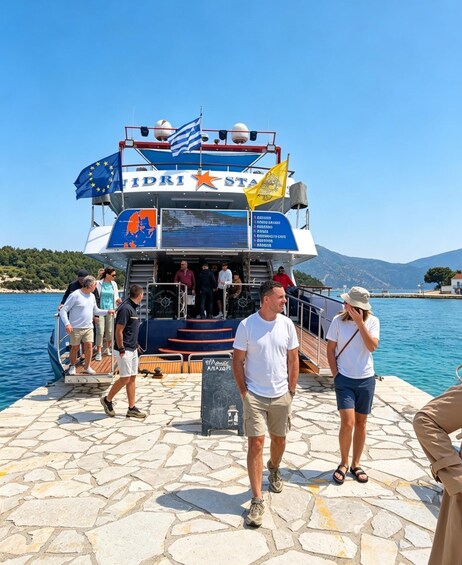 A ferry with the name 'IDRI STA' and flags, people boarding, and a stone pier. 2