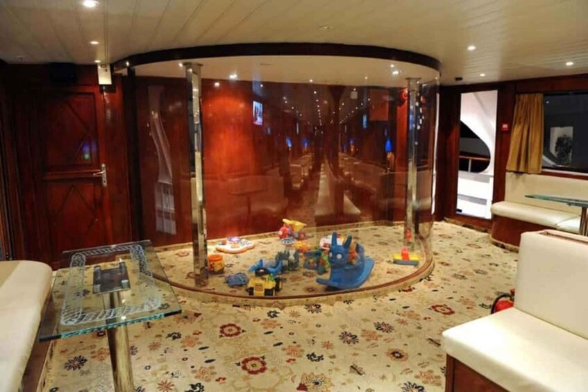 A luxurious interior with a curved ceiling, a glass partition, and a carpeted floor. 3