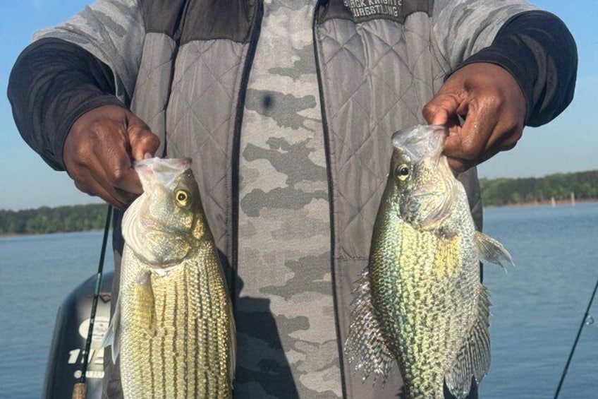 A person holding two fish. 3