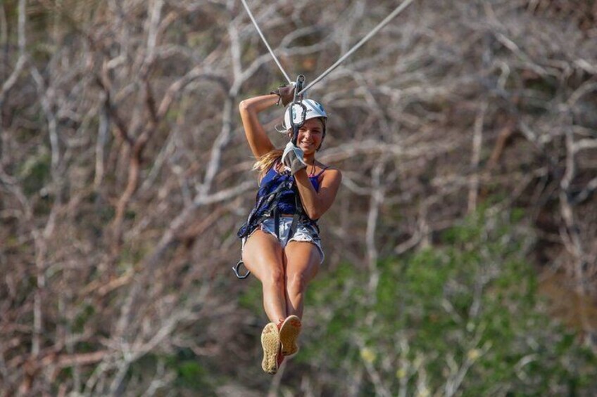 A person zip-lining through a forested area. 4