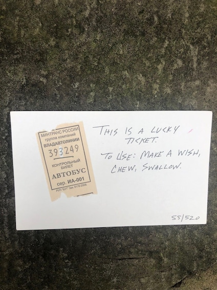 A ticket with a handwritten note on it. 2