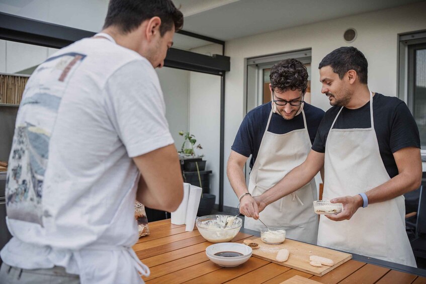 Three people preparing food in a kitchen. 3