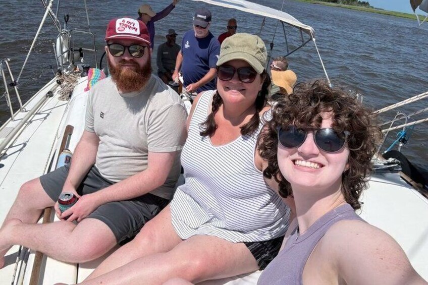 People on a boat with a water body in the background. 5