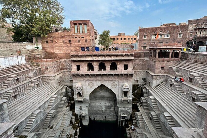 A historical fort with a large central archway, surrounded by stone steps and walls. 4