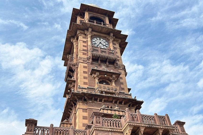 A tall clock tower with intricate architectural details and a clear sky in the background. 5