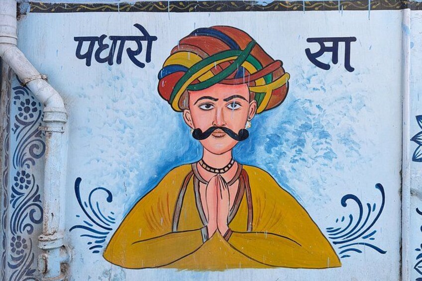 A mural of a man in traditional attire with text in a non-English script. 2