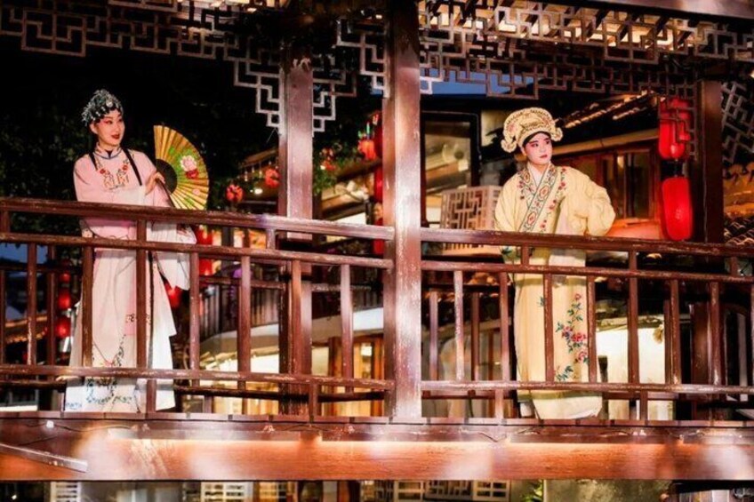 A traditional Chinese architectural structure with intricate wooden lattice work and a railing. 5