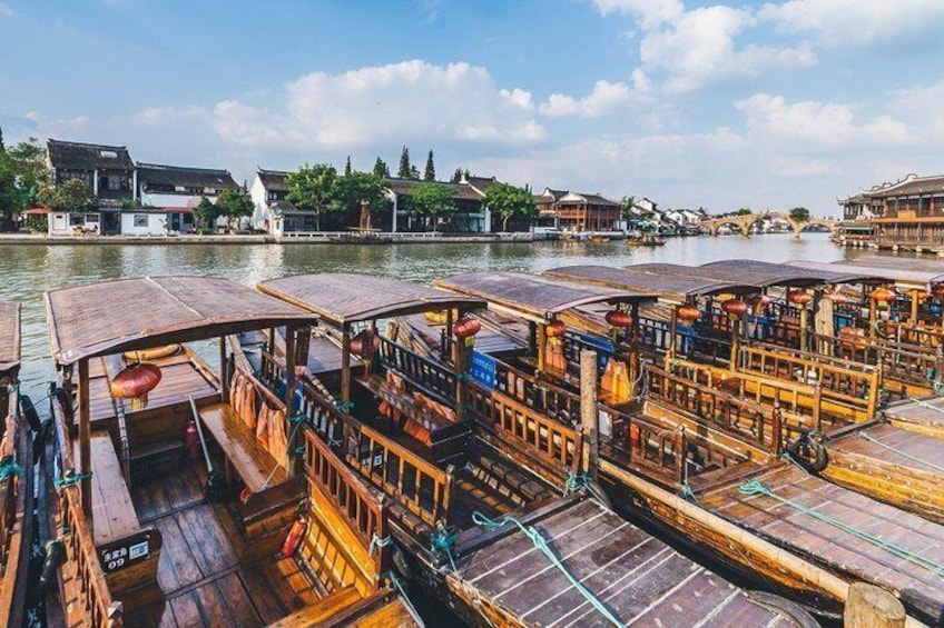 A river with traditional wooden boats docked along the shore. 3