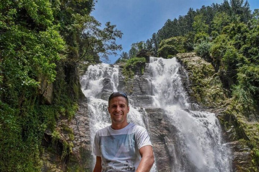 A waterfall surrounded by lush greenery. 4