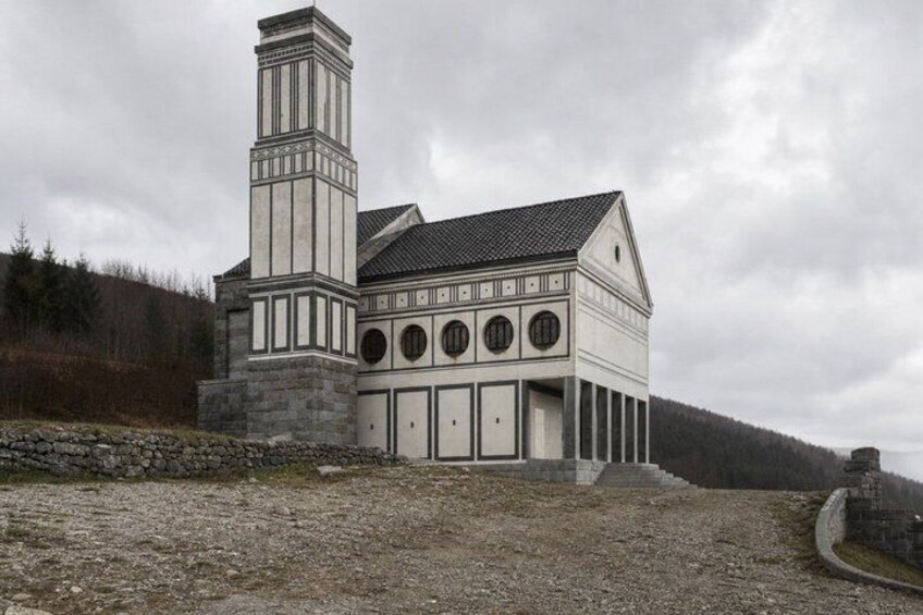 A large, white church with a tall tower and multiple arched windows. 5