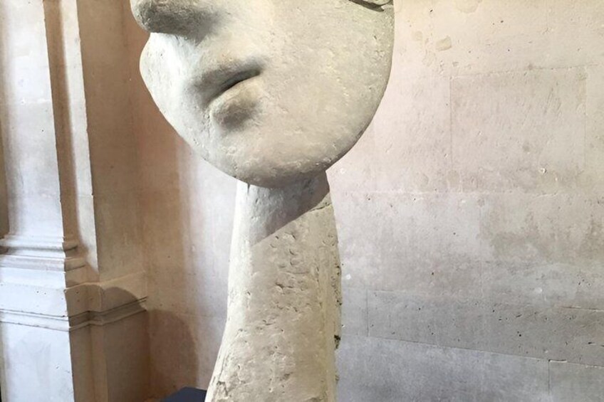 A stone bust sculpture with a visible crack on the left side. 4