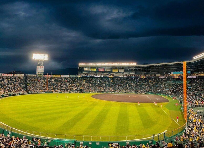 A baseball stadium at night with a dark sky. 3